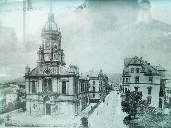 Historical black and white view of a street with a synagogue