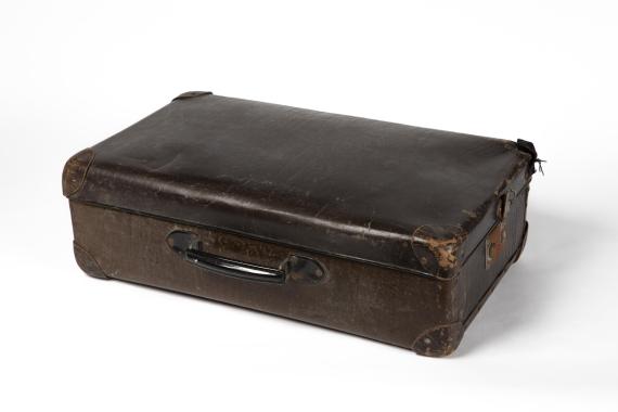 Photo of a brown leather suitcase with metal handle