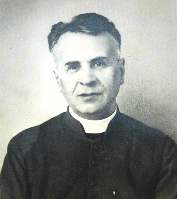 Black and white photograph of a man looking towards the camera