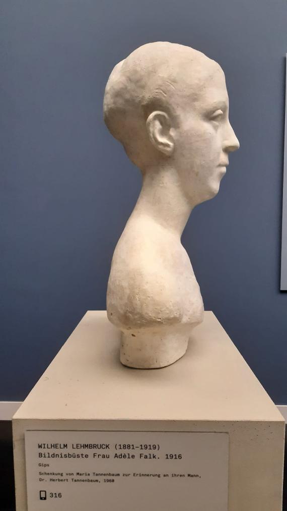 Photograph of a portrait bust standing on a pedestal in profile view