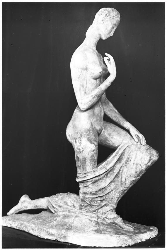 Black and white photo of a sculpture in front of a black background