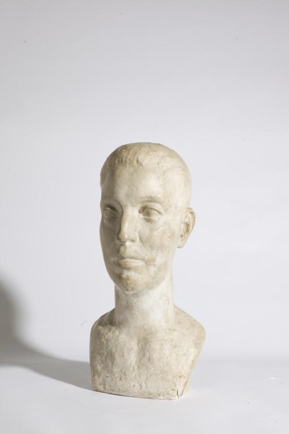 Photograph of a portrait bust standing on a white background