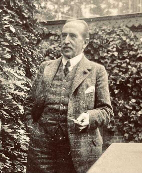 Photograph with half-length portrait of an elderly man in a suit