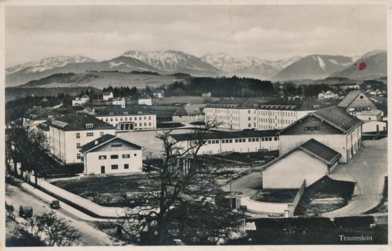 Postcard with a bird's eye view of a barracks area, mountains in the background, black and white