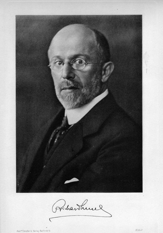 Black and white photograph of an elderly man with glasses in three-quarter profile