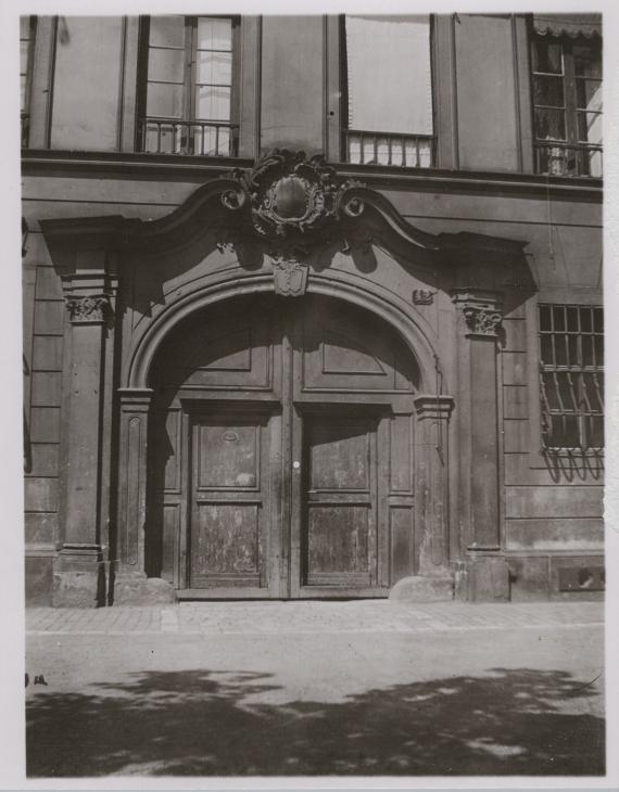 Black and white photo of a large entrance portal of a house