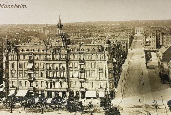 Historical picture. View from above of a large building and a long street