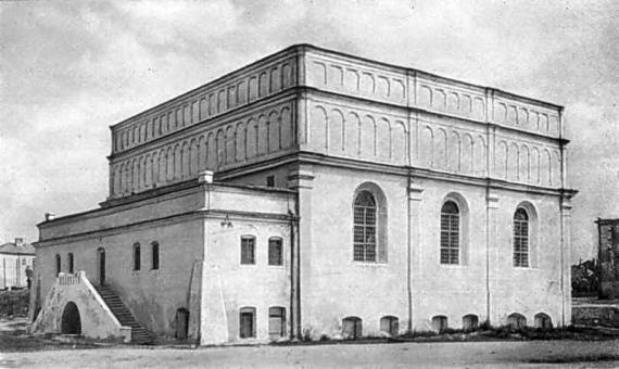 Black and white photograph of a detached, high-rise, square building