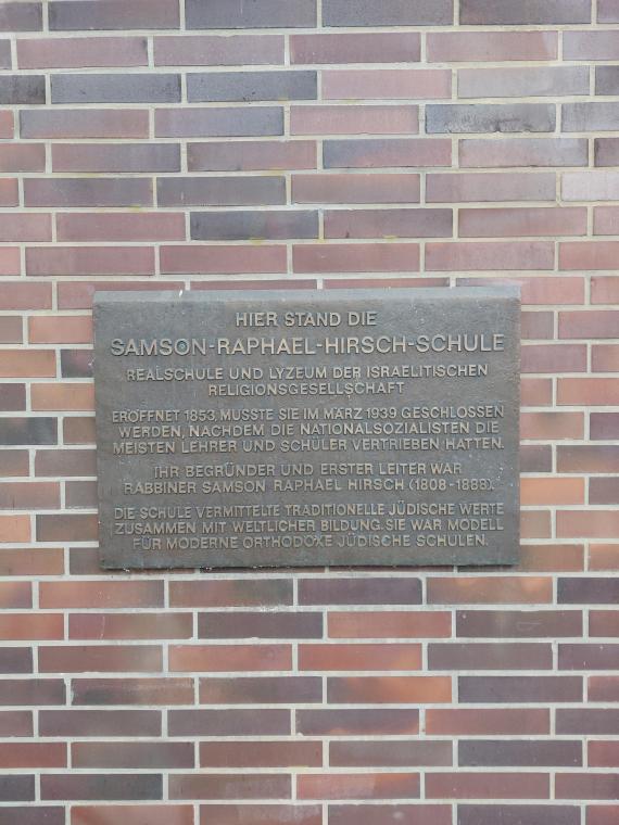 The photo shows the memorial plaque for the Samson Raphael Hirsch School