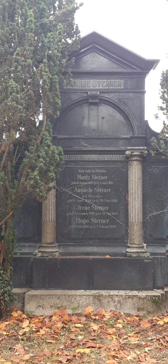 Large dark gravestone, with a tree to the left