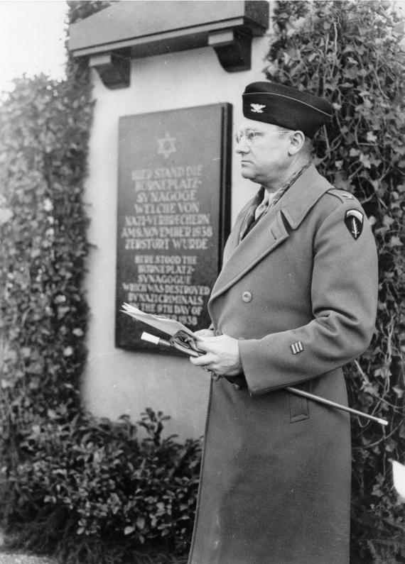 You can see Colonel James R. Newman in front of a memorial plaque