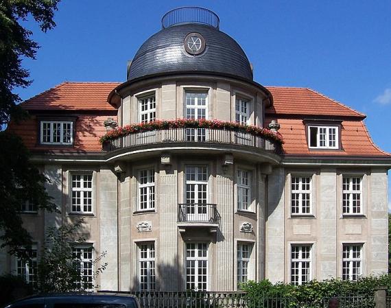 A recent photo shows a magnificent neoclassical villa with a round building section and high windows