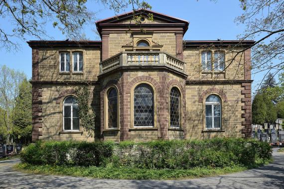 big house surrounded by black tombstones