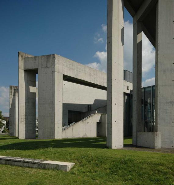 Concrete columns on green lawn