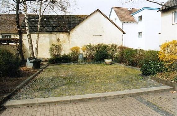 small, paved square with memorial stone at the end