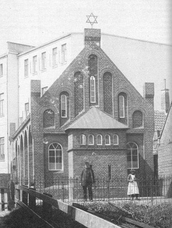 black and white view of synagogue building with Star of David on pointed roof