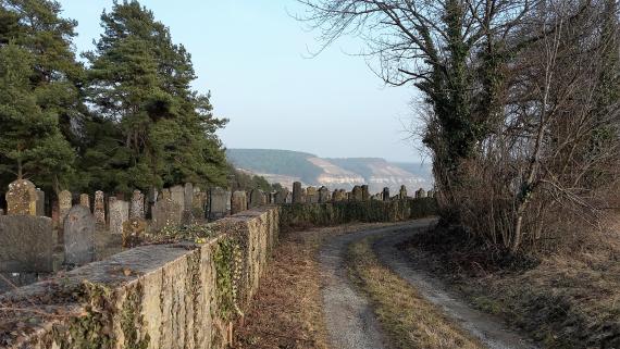 Cemetery Laudenbach, cemetery wall, road, far view into the Main valley.