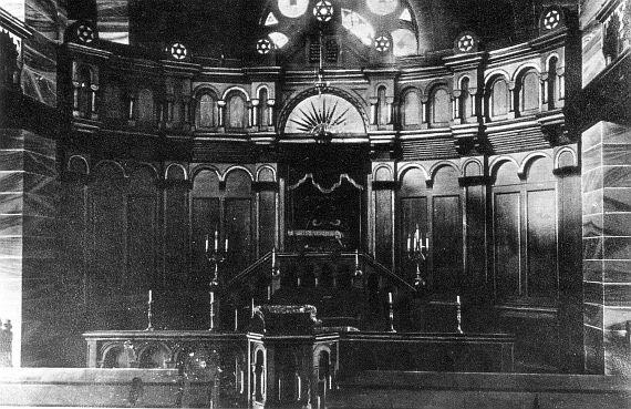 Black and white photo: paneled shrine, stars of David decorate the tops of the pillars