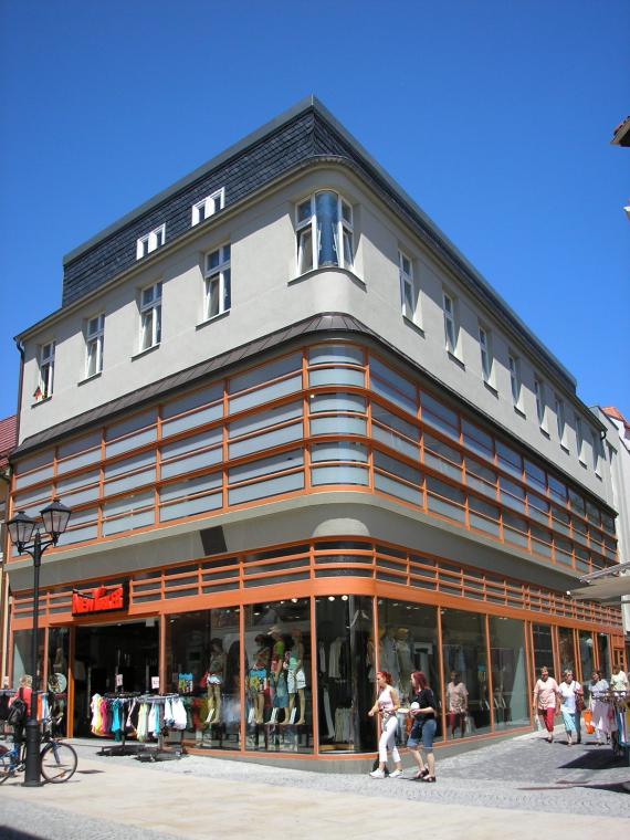 Corner view of New Yorker - store under blue sky.