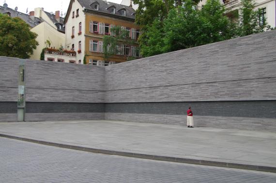 Gray high stone walls with names of murdered Jewish people