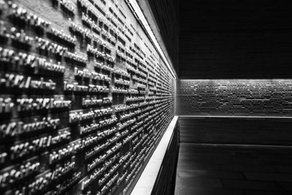 Long, gray wall with names of murdered Jews