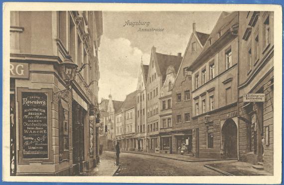Historical picture postcard of Augsburg, Annastrasse, on the left in the foreground the corner of the house of the manufactory Georg Rosenberg with a large advertising board on which various items for sale in the store are listed. On the right side of the picture, - the continuing Annastrasse with more houses and stores.