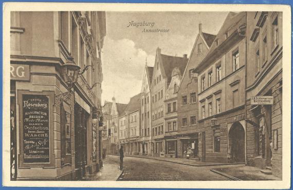 Historical picture postcard of Augsburg, Annastrasse, on the left in the foreground the corner of the house of the manufactory Georg Rosenberg with a large advertising board on which various items for sale in the store are listed. On the right side of the picture, - the continuing Annastrasse with more houses and stores.