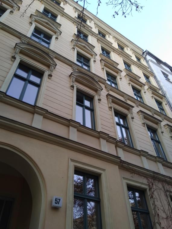 House entrance and facade with many windows