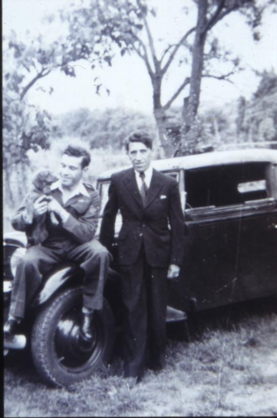 Black and white photograph of Jan and Samuel Lazarus standing in front of a car.