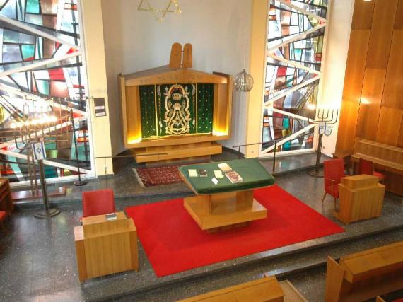 Interior in prayer hall with red carpet and large decorated windows